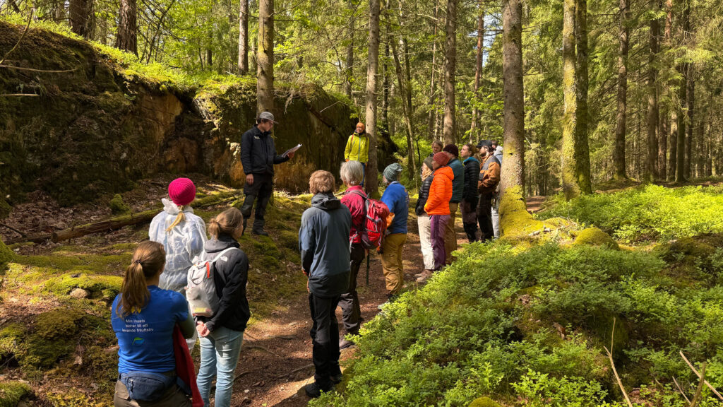 En av Västkuststiftelsens naturvårdare står framför en grupp med ideella. Foto.