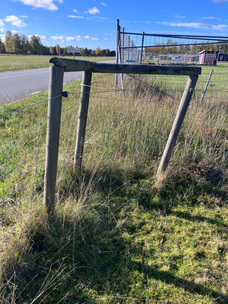 Ett lutande stängselhörn. Foto.